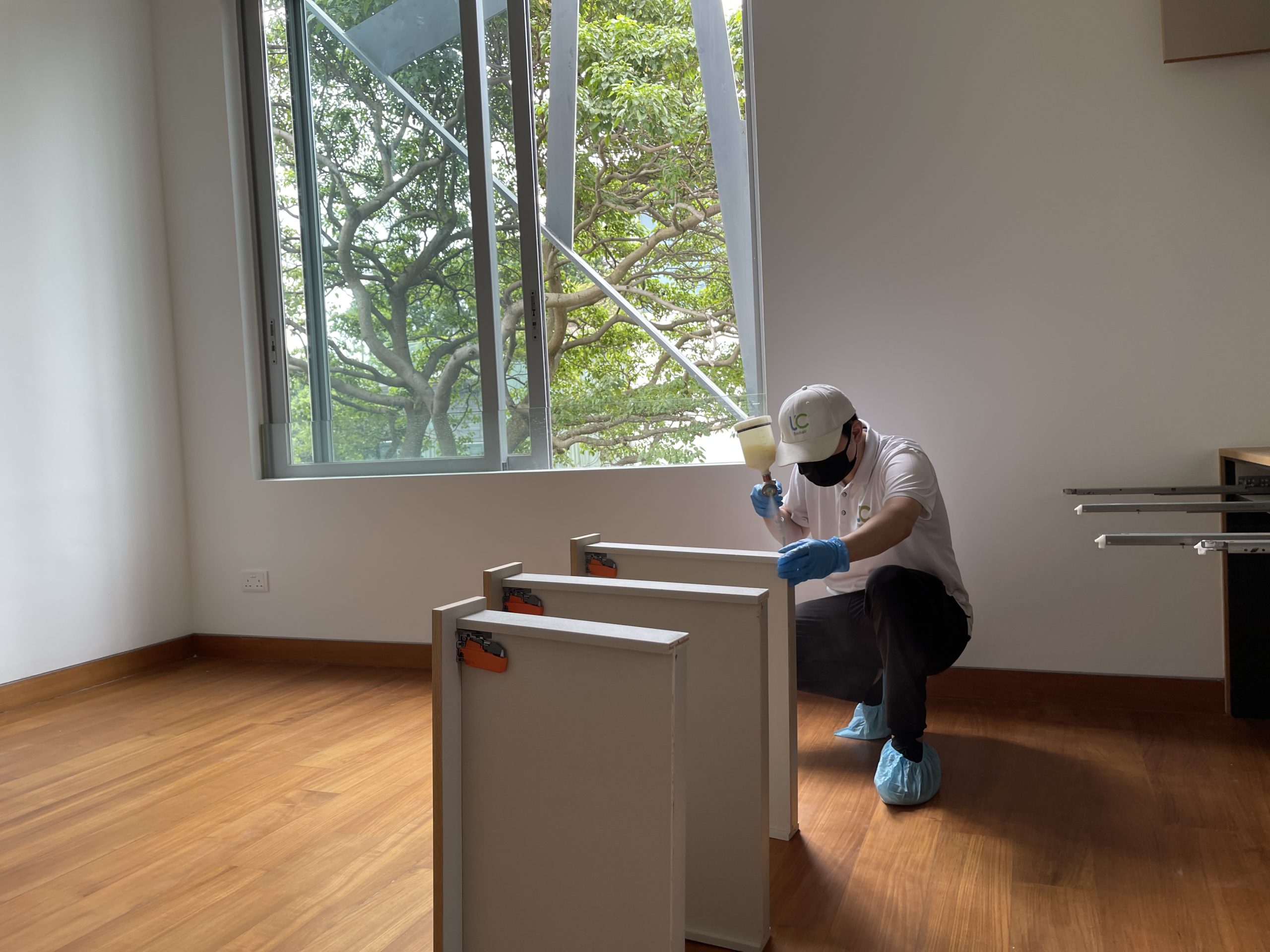 UC Fresh Air technician applying formaldehyde removal spray on new cabinet drawer